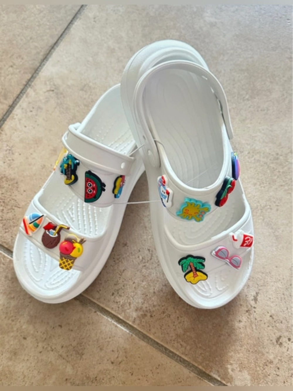 New without tags. Women’s 10.5
 Faux Croc white women’s sandals with Lots charms
